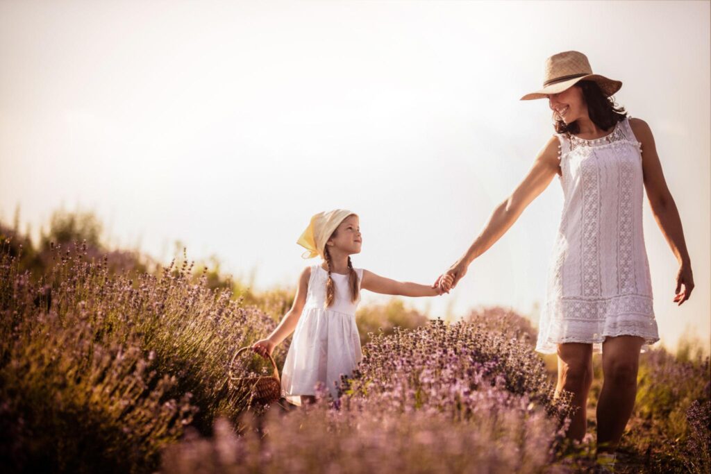 helping our daughters discover their identity - mother daughter walking in flowers